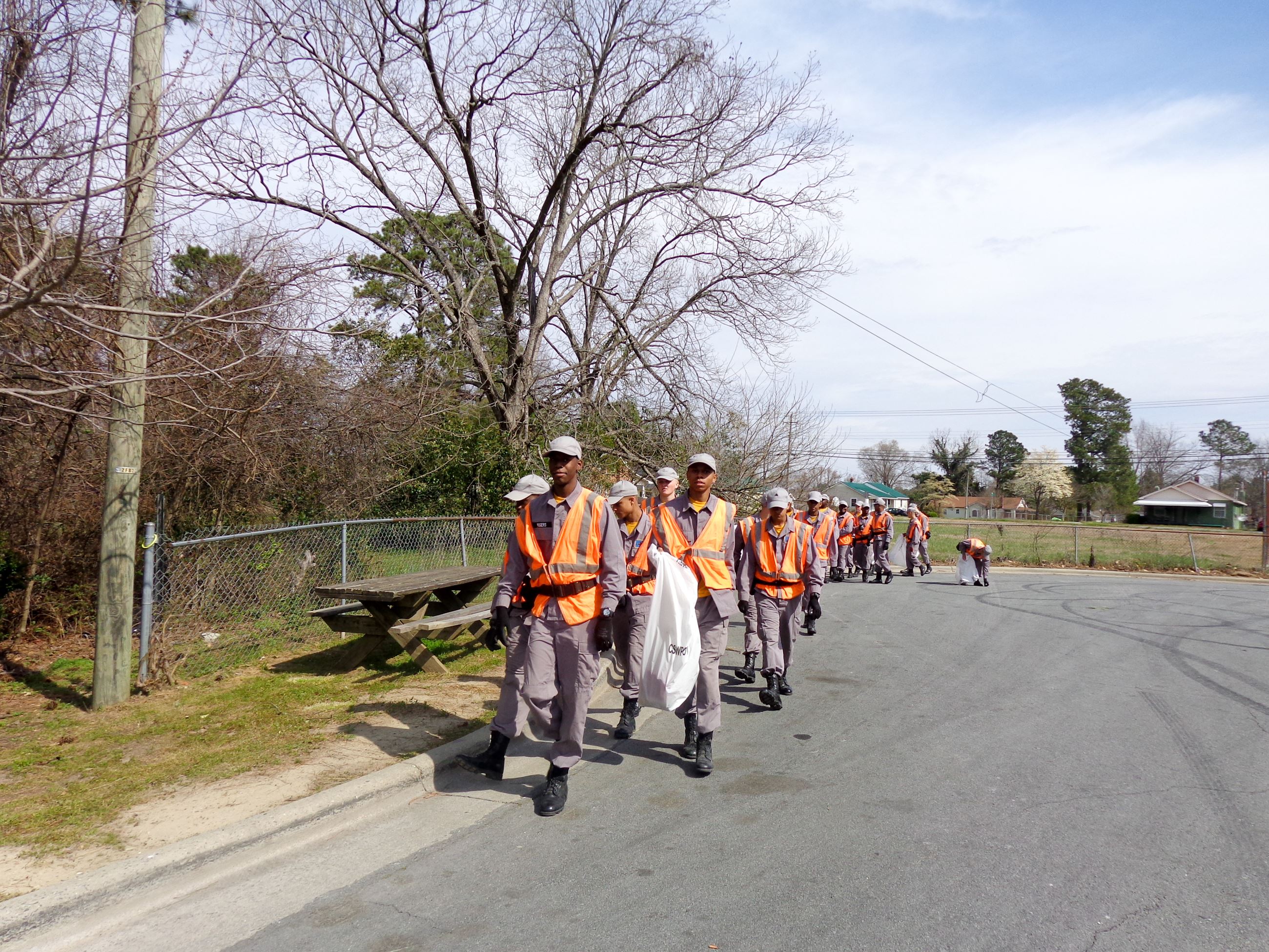 People Walking with Trash Bags